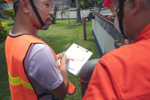 The maintenance technician is inspecting the wastewater treatment equipment of the treatment plant so that it can be operated at all times.