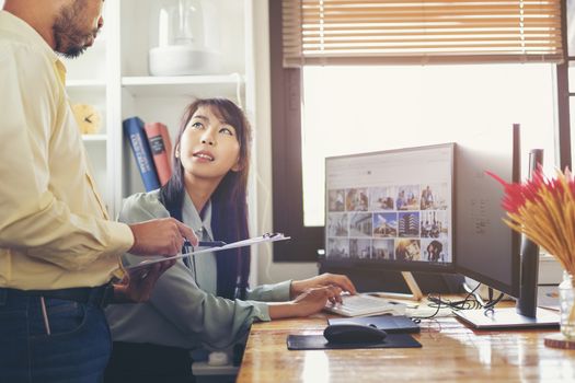 The image of the employee is explaining the job to the manager. Talking during work. Teamwork Concept