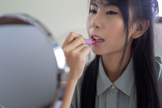 Young businesswoman made up at work, a beautiful young woman doing makeup before work starts to brighten up and add to her confidence.