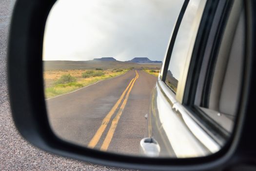 Nature Painted Desert in Arizona seen from the rearview mirror of a car