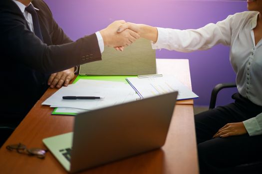 Close up hand of two businessman shaking hand after finish agreement and successful negotiations in office