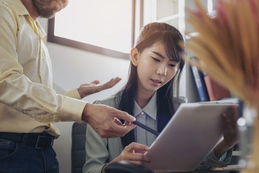 The image of the employee is explaining the job to the manager. Talking during work. Teamwork Concept