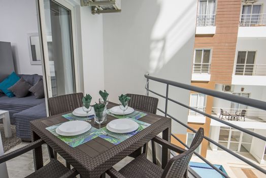 Terrace furniture of a luxury apartment in tropical resort with plastic dining table furniture and lounge