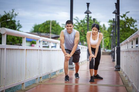 Couples who take care of their health by exercising happily in the city. Health care concept