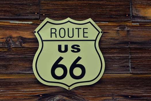 Historic U.S. old Route 66 sign with wooden background.