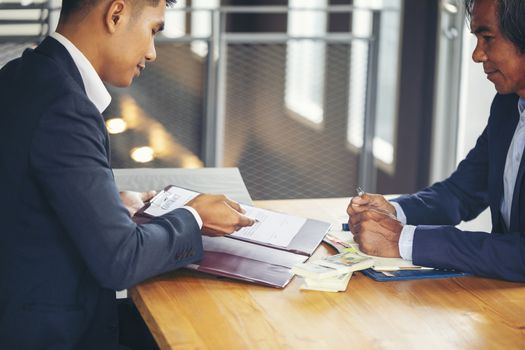 Image of business people hands working with papers at meeting. Businessman holding pens and holding graph paper are meeting to plan sales to meet targets set in next year.