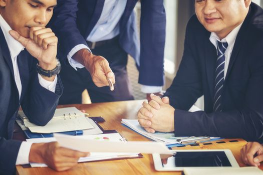 Image of business people hands working with papers at meeting. Businessman holding pens and holding graph paper are meeting to plan sales to meet targets set in next year.