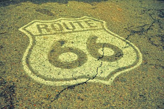 Historic U.S. old Route 66 sign on the asphalt.