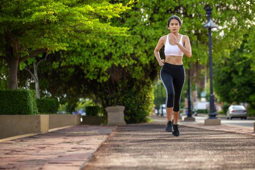 Beautiful woman jogger outdoor living healthy lifestyle in city park. Concept sport and a healthy lifestyle in the city
