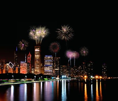 Chicago night skyline across Lake Michigan with fireworks.