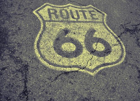 Historic U.S. old Route 66 sign on the asphalt.