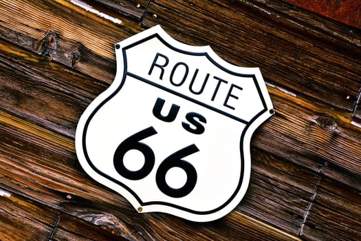 Historic U.S. old Route 66 sign with wooden background.