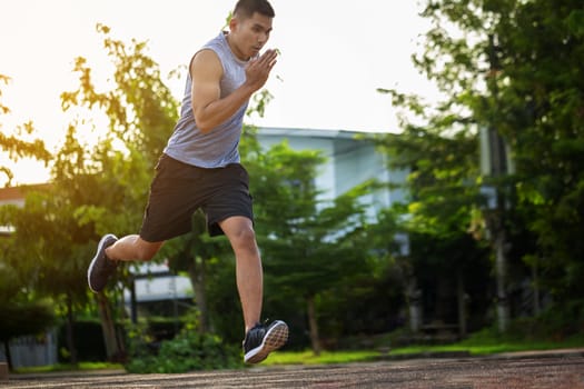 Portrait of fit and sporty young man running in the city. Concept sport and a healthy lifestyle in the city