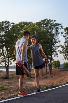 Running at sunrise couple exercising for marathon and workout 
fitness, sport, people and lifestyle concept - Happy couples exercising with outdoor running