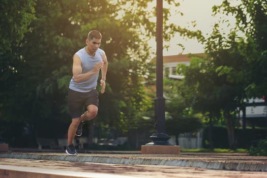 Portrait of fit and sporty young man running in the city. Concept sport and a healthy lifestyle in the city