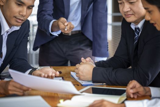 Image of business people hands working with papers at meeting. Businessman holding pens and holding graph paper are meeting to plan sales to meet targets set in next year.