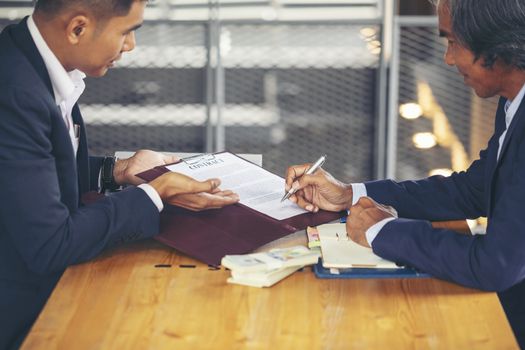 Image of business people hands working with papers at meeting. Businessman holding pens and holding graph paper are meeting to plan sales to meet targets set in next year.