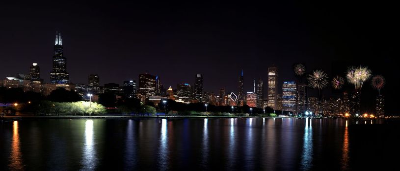 Chicago night skyline across Lake Michigan with fireworks.