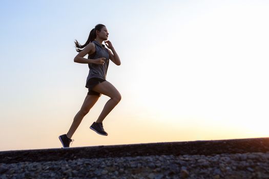 young woman runner running on road. healthy lifestyle young fitness woman running