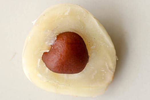 Close up of single piece of Snake fruit with seed. Top view of single healthy fruit. Salak pondoh is one of the salak cultivars that mostly grows in area of Bali. Macro photo of Sweet Salacca.