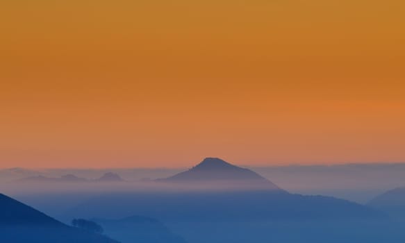 Dawn with fog among the hills.