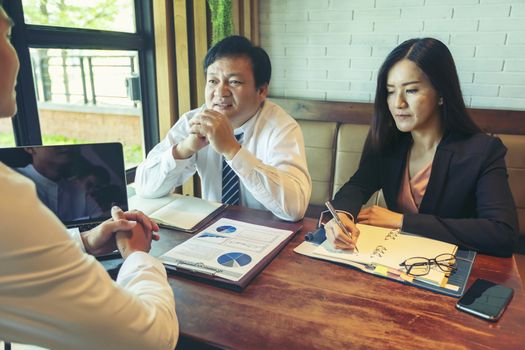 Financial consultant, credit expert explaining terms of contract to client or investor. Attentive businessman listening to business partner talking during negotiations