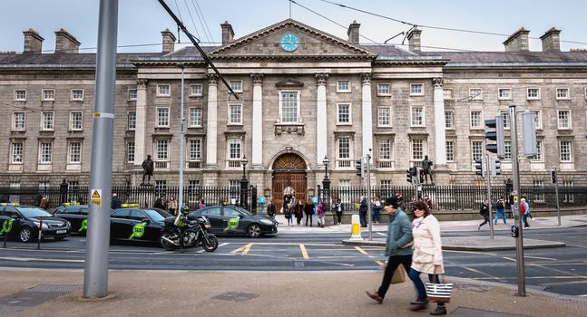 Dublin, Ireland - February 11, 2019: People walking in the courtyard of Trinity College in the city center on a winter day