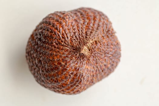 Close up of single piece of Snake fruit. Top view of single healthy fruit. Salak pondoh is one of the salak cultivars that mostly grows in area of Bali. Macro photo of Sweet Salacca zalacca.