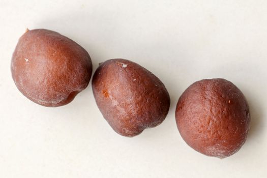 Snake fruit seeds on a white background. Close up of seeds. Salak is a fruit which in Indonesia has almost the same fruit skin as snake skin. The taste of the fruit is delicious.