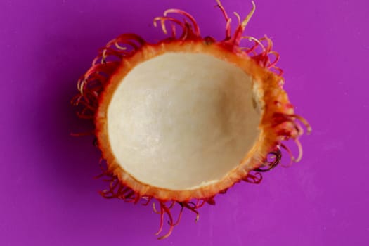 Peel of tropical fruit Rambutan. Natural fresh ripe Nephelium lappaceum peeled. Have a sweet taste. Healty fruit with many nutrients that are good for body. Isolated on white background.