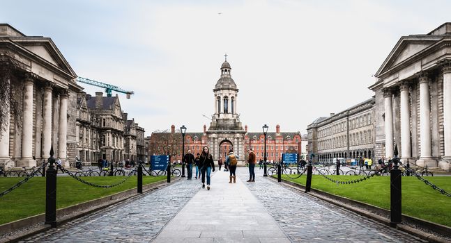 Dublin, Ireland - February 11, 2019: People walking in the courtyard of Trinity College in the city center on a winter day