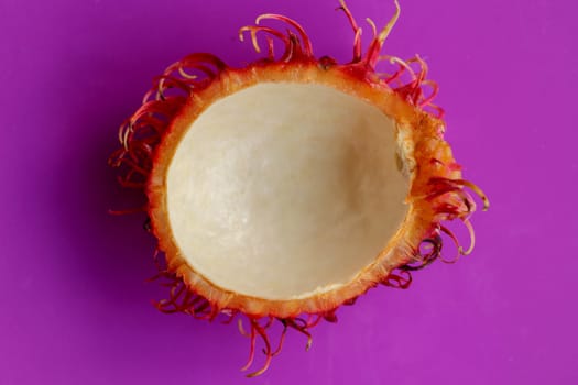 Peel of tropical fruit Rambutan. Natural fresh ripe Nephelium lappaceum peeled. Have a sweet taste. Healty fruit with many nutrients that are good for body. Isolated on white background.