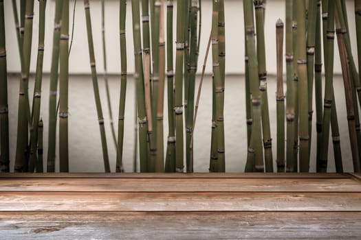 Wood tabletop in perspective view with bamboo vintage background