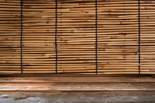 Wood tabletop in perspective view with bamboo curtain retro background