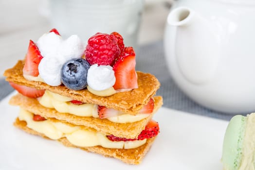 Mille Feuille with tea set on table in cafe.