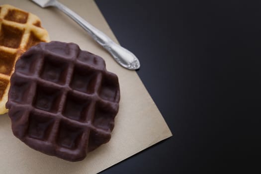 Waffle coated with chocolate as snack for breakfast.