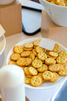 Pile of crackers in plate, selective focus.