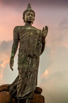 Big Buddha statue or monument at sunrise or sunset in HDR.