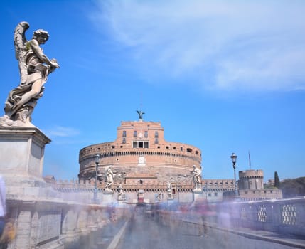 Bridge to the castle of San Angelo with many people in Rome.