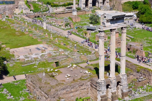 ROME, ITALY - APRIL 10, 2017: Tourists visit the Roman Forum with the Temple of Castor and Pollux in first term in Rome, Italy on April 10, 2017.