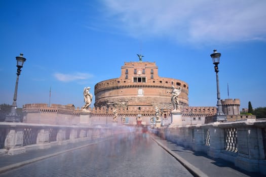 Bridge to the castle of San Angelo with many people in Rome.