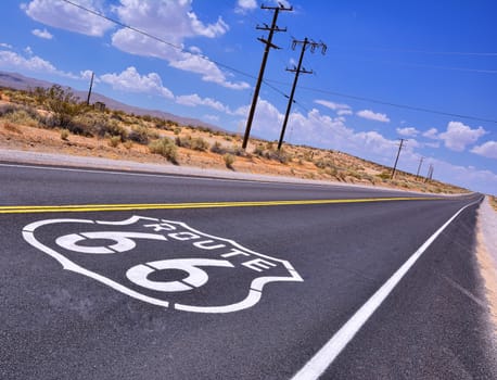 U.S. Route 66 highway, with sign on asphalt on California.