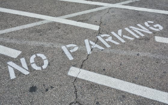 No parking sing on asphalt.