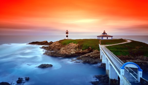 Idyllic view on seashore of Pancha island, Spain at sunset of red and orange colors