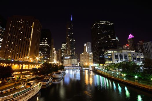 Chicago, Usa - July 15, 2017: Downtown Chicago at night. View of Illuminated buildings in the central part of the city. Trump Tower and The Wrigley Building reflected in Chicago river.