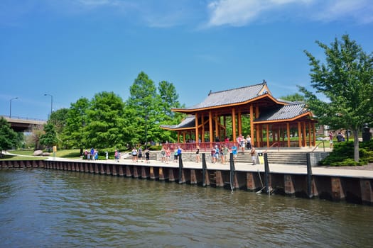 Chicago, IL, July 15, 2017: Typical scene at Chicago's Chinatown: People wait for the water taxi at the pavilion at Ping Tom Memorial Park. Chinatown attracts many visitors every day.