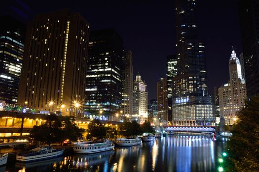 Chicago, Usa - July 15, 2017: Downtown Chicago at night. View of Illuminated buildings in the central part of the city. Trump Tower and The Wrigley Building reflected in Chicago river.