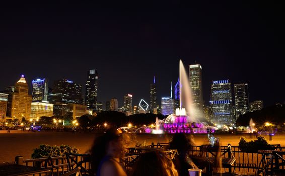 Chicago skyline panorama with skyscrapers and Buckingham fountain at night.