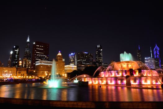 Chicago skyline panorama with skyscrapers and Buckingham fountain at night.