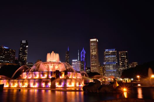 Chicago skyline panorama with skyscrapers and Buckingham fountain at night.